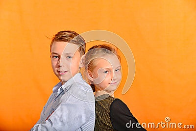 The boy plays the clarinet in the girlâ€™s ear, the outraged girl waves her arms Stock Photo